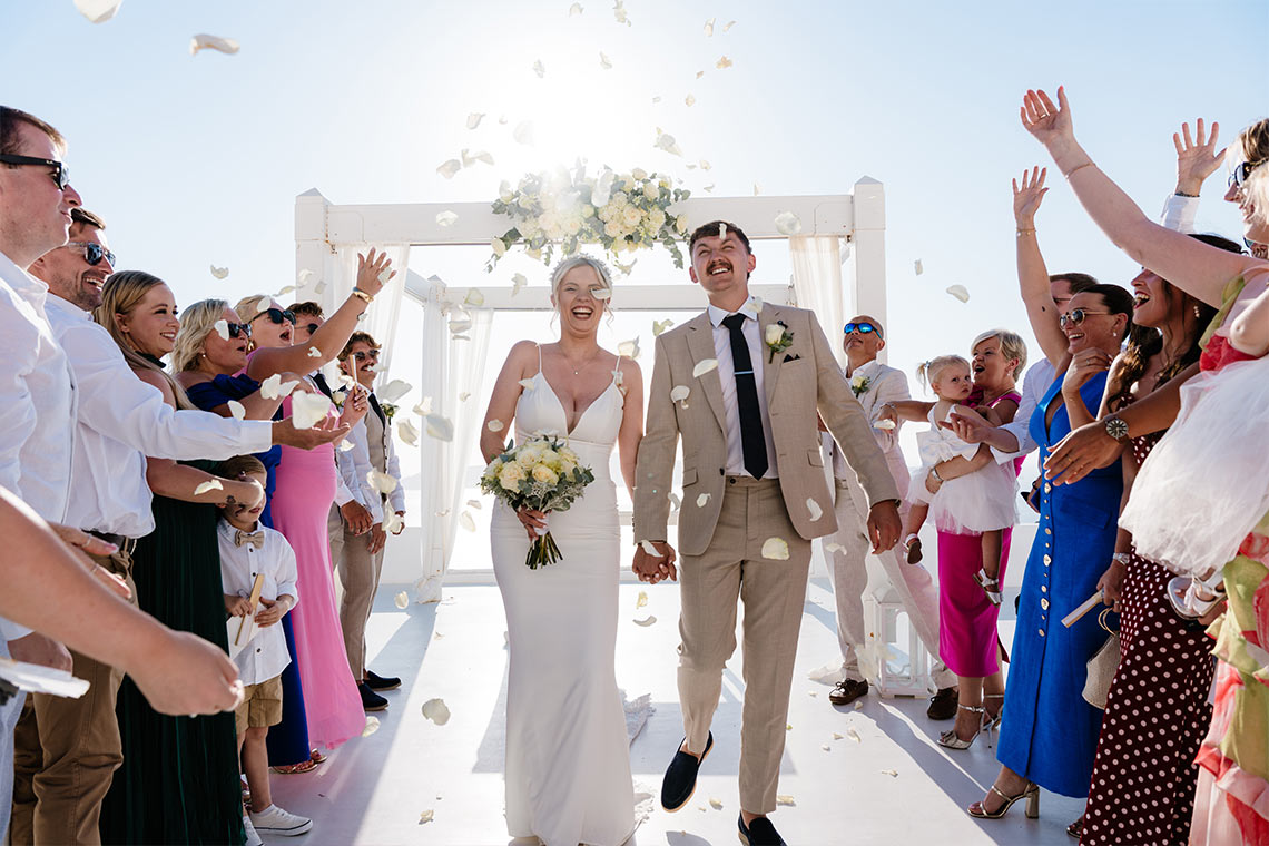 Wedding ceremony on the Santorini caldera at golden hour