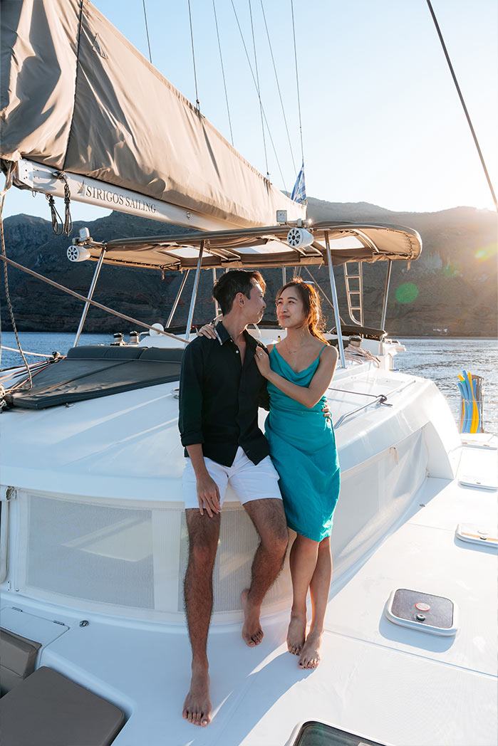 Couple photographed on a catamaran photo tour off the Santorini coast